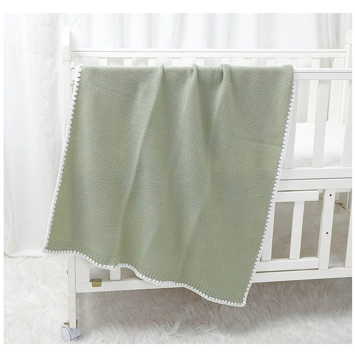 Archer Knitted Baby Blanket. Size 90x70 cm on Cot