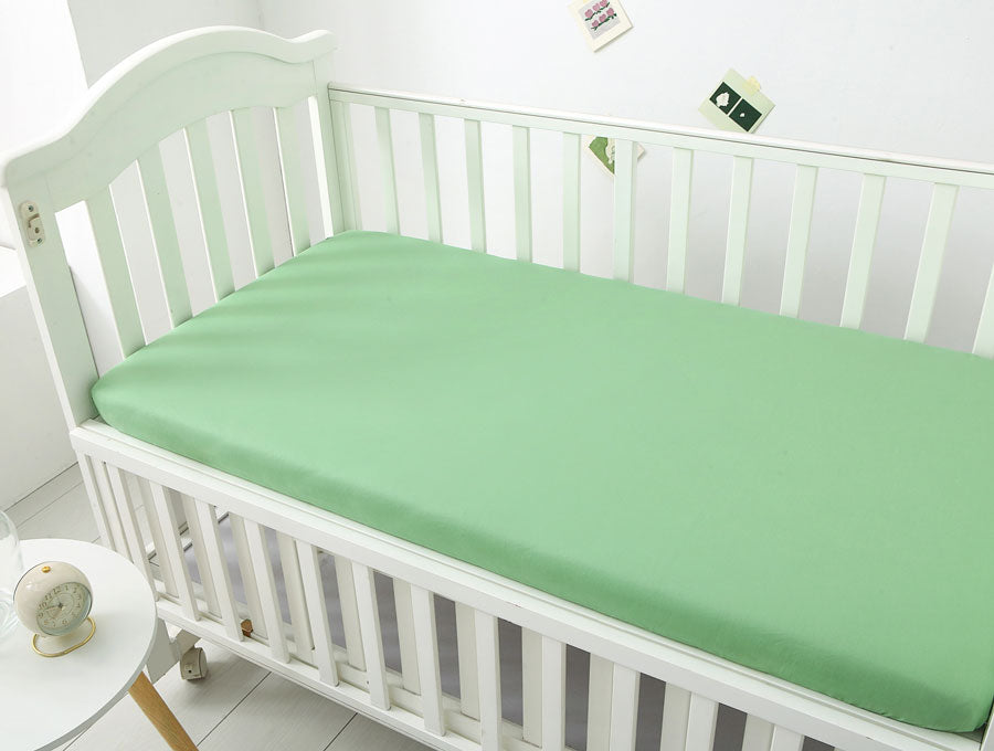 Jungle Green Baby Nursery Fitted Cot Sheet on cot