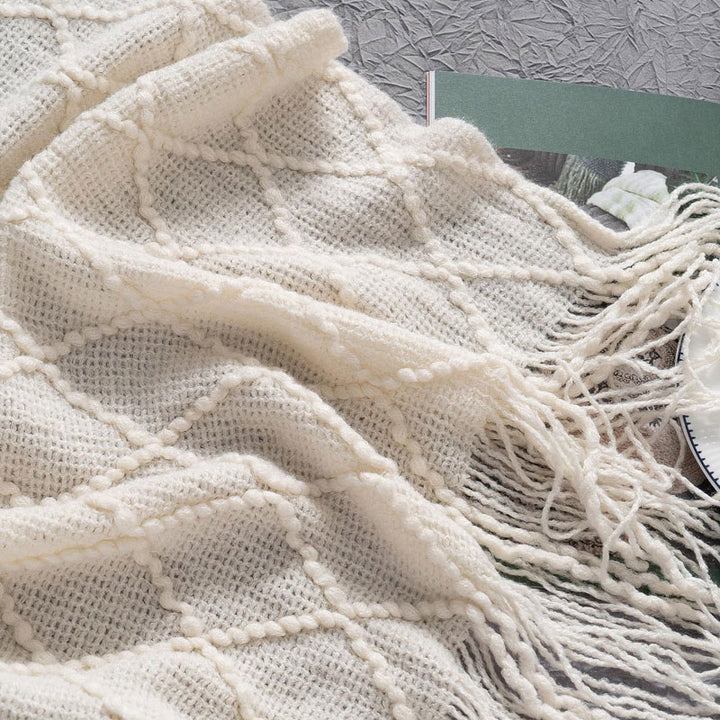 Knit Throw Blanket with Tassels in Cream Color. Closeup. Size 130-150 cm