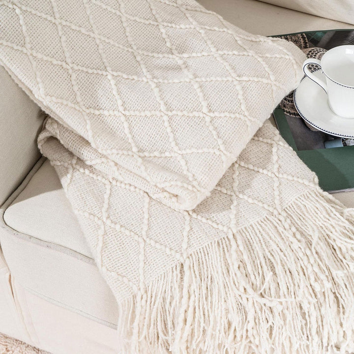 Knit Throw Blanket with Tassels in Cream Color. Folded. Size 130-150 cm