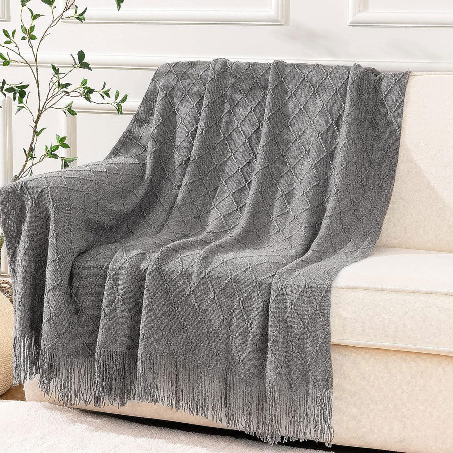 Knit Throw Blanket with Tassels in Grey Color. On sofa 2. Size 130-150 cm