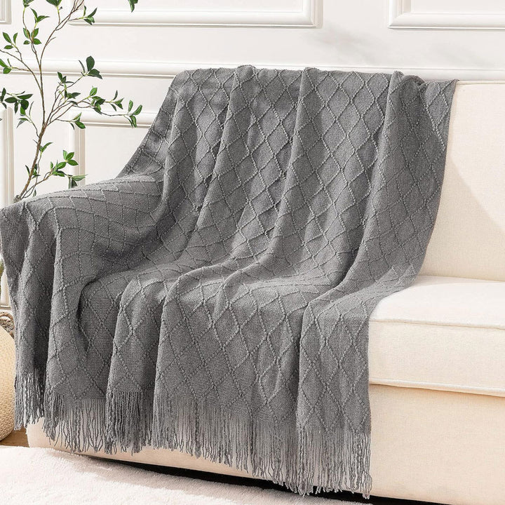 Knit Throw Blanket with Tassels in Grey Color. On sofa 2. Size 130-150 cm