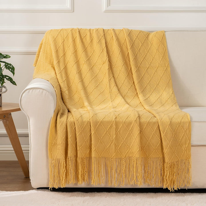 Knit Throw Blanket with Tassels in Mustard Color. On sofa 2. Size 130-150 cm